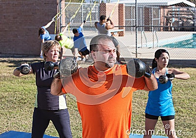 Three Adults Exercising Outdoors Stock Photo