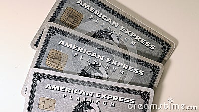 Three American Express Amex Platinum Cards on a White Table Editorial Stock Photo