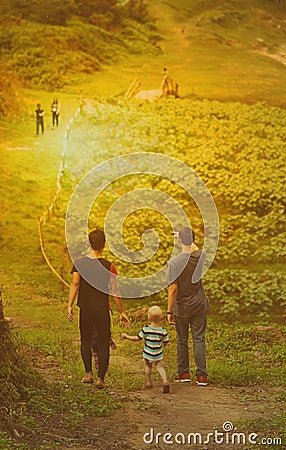 Man and child way in garden way. Editorial Stock Photo