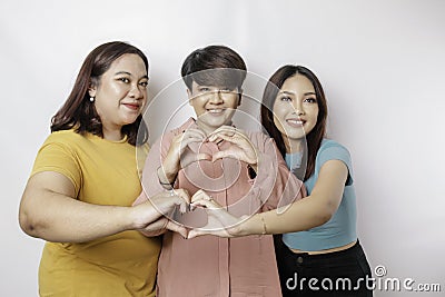 Three Asian women feel happy and a romantic shapes heart gesture expresses tender feelings, close friendship concept Stock Photo
