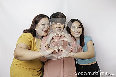 Three Asian women feel happy and a romantic shapes heart gesture expresses tender feelings, close friendship concept Stock Photo