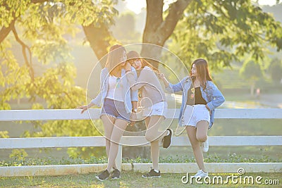 Three asian young ladys enjoy afternoon heat in garden . Stock Photo