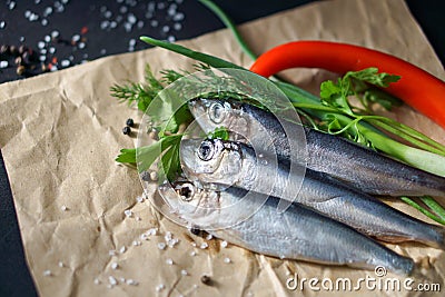 Three Atlantic herrings on craft paper. Stock Photo