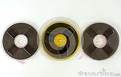 Three audio tapes on a reel of different colors, on a white background Stock Photo