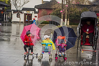 Three babies and a rickshaw man. Editorial Stock Photo