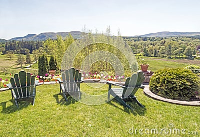 Adirondack chairs on grass lawn overlooking Berkshires in Spring Stock Photo