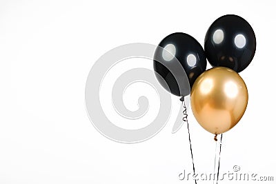 Three balloons, black and gold, isolate on a white background with place for text Stock Photo