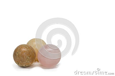 Three balls made of natural stone. Rose quartz, yellow calcide and jasper. Isolated on white, copy space Stock Photo