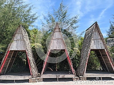 three beach huts neatly arranged with beautiful cypress trees and blue sky. Stock Photo