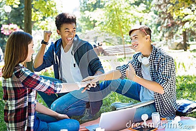 Three beaming promising businessmen achieving success Stock Photo