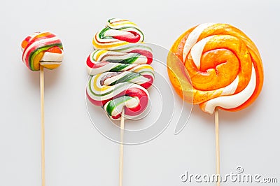 Three beautiful colorful lollipops on sticks Stock Photo