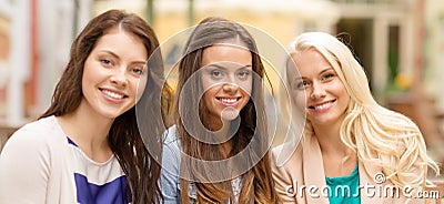 Three beautiful girls drinking coffee in cafe Stock Photo