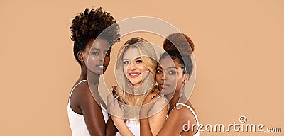 Three beautiful multi ethnic women posing together, looking at camera. Stock Photo