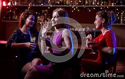 Three beautiful women at bar Stock Photo