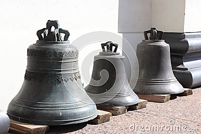 Three bells on wooden planks. Stock Photo