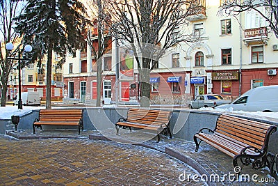 Three benches in park. Snow covered benches and trees in city park. Winter park, Editorial Stock Photo