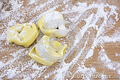 Three big ravioli on the wooden table Stock Photo