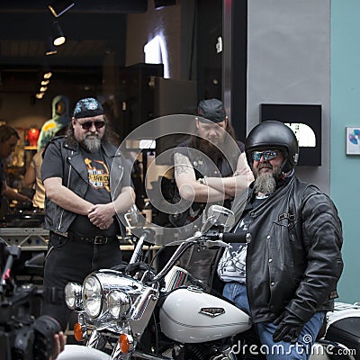 Three bikers with a motorcycle pose Editorial Stock Photo