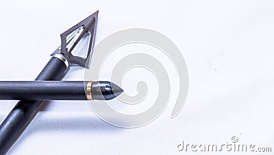 A three blade broadhead on the end of a carbon arrow and another with a field point on a white background Stock Photo