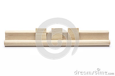 Three blank scrabble tiles on a wooden rack Stock Photo