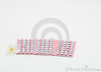 Three blister of hormone pills for treatment menopausal woman and flower Stock Photo