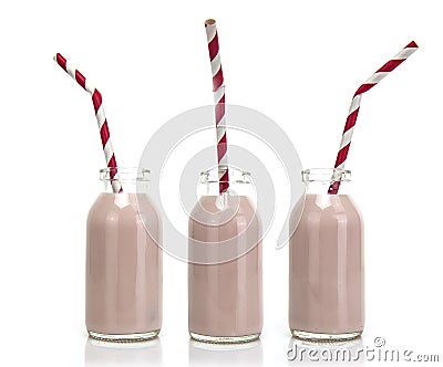 Three Bottles of pink milk with red and white striped straws Stock Photo