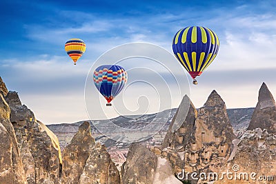 Three bright multi-colored hot air balloons flying in sky Stock Photo