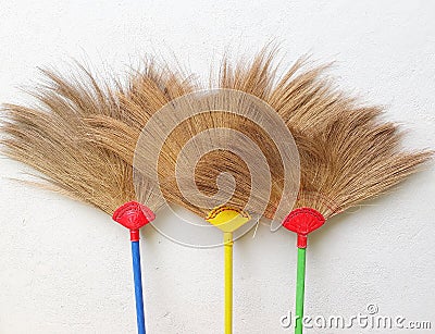 Three broom colorful on white background Stock Photo