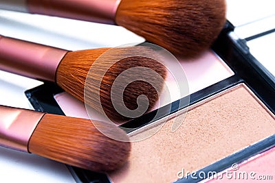 Three brushes and makeup eyeshadow palette isolated on white background. Stock Photo