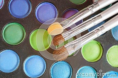 Three Brushes on the palette of eye shadow Stock Photo