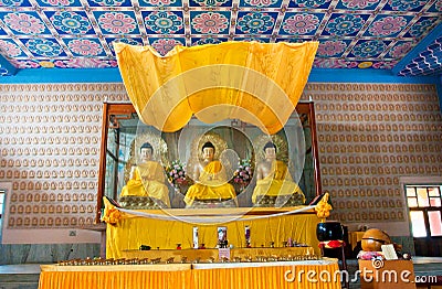 Three Buddha statues inside the buddhist temple Editorial Stock Photo