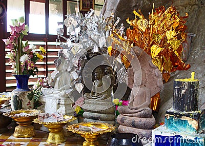 Three Buddhas and offerings Stock Photo