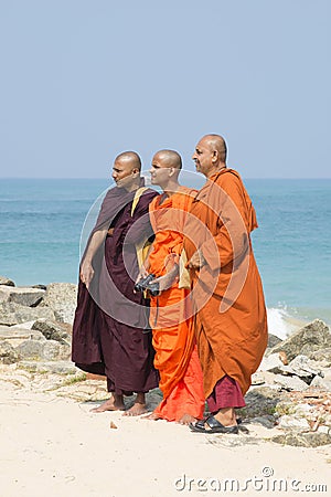 Three Buddhist monks on the background of the ocean Editorial Stock Photo