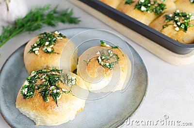 Three buns with garlic and dill sauce with oil in a gray plate. Preparation of pampushky (Pampushky) Stock Photo
