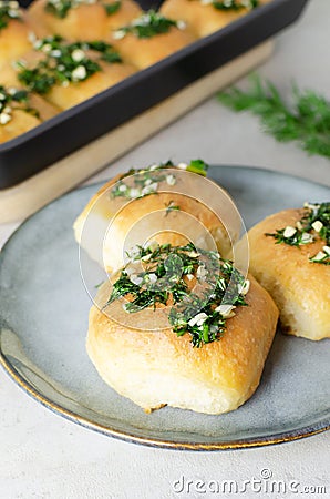 Three buns with garlic and dill sauce with oil in a gray plate. Preparation of pampushky (Pampushky) Stock Photo