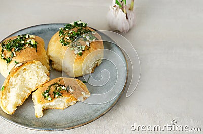 Three buns with garlic and dill sauce with oil in a gray plate. Preparation of pampushky (Pampushky) Stock Photo