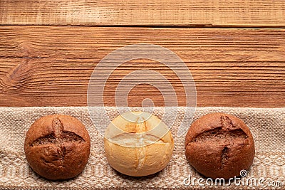 Three buns on wooden table Stock Photo