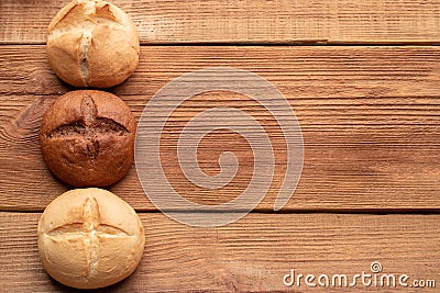 Three buns on wooden table Stock Photo