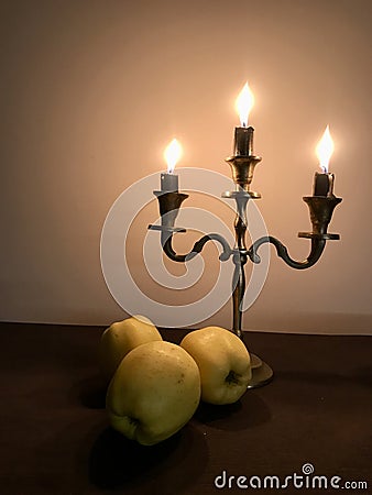 three burning candles burn down on a candlestick on Hanukkah Stock Photo