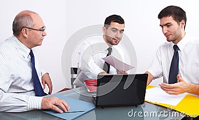 Three businessman sitting at table during meeting Stock Photo