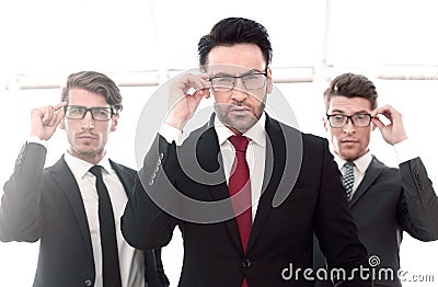 Three businessmen with glasses, pretentious looking at the camera Stock Photo