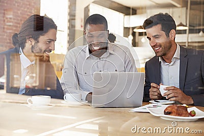 Three Businessmen Meeting In Coffee Shop Shot Through Window Stock Photo