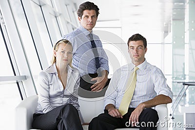Three businesspeople sitting in office lobby Stock Photo