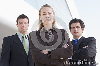 Three businesspeople standing outdoors by building Stock Photo