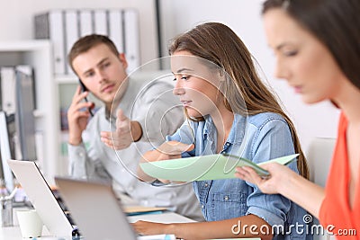 Three businesspeople working hard at office Stock Photo