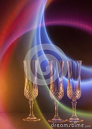 Three Wine Glasses with a Rainbow Swoosh Background Stock Photo