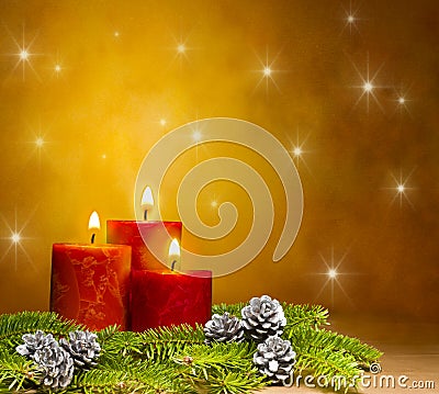 Three candles in a festive Christmas setting Stock Photo