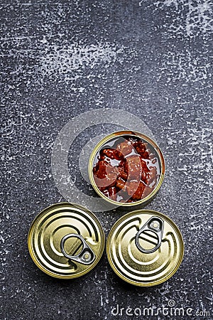 Three canned fish cans, one open circular Stock Photo