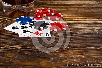 Three cards, poker chips, on a wooden background Stock Photo
