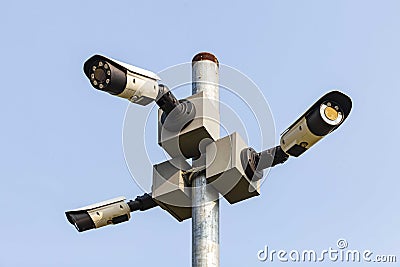 CCTV camera on a tall pole at the park Stock Photo